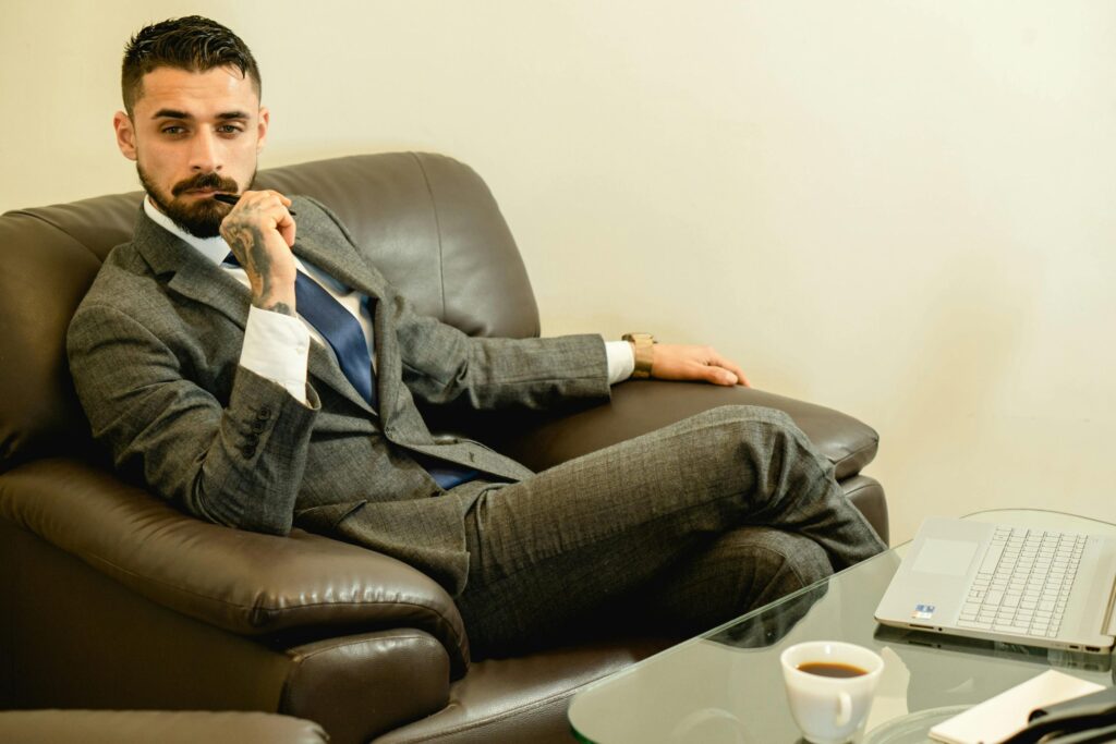 Photo of a Man in a Gray Suit Thinking while Sitting